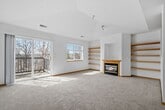 This contemporary apartment in Boulder Ridge, Apple Valley, offers 980 square feet of thoughtfully designed living space. The single-story layout boasts two bedrooms and two bathrooms, with the primary bedroom generously sized at 230 square feet. The heart of the home is an open-concept living area, featuring a cozy gas fireplace with a warm wood mantle, perfect for Minnesota winters.

Throughout the apartment, you'll find sleek grey wood-look flooring that adds a modern touch while providing durability. The kitchen, though compact, is efficiently designed with ample wooden cabinetry, white appliances, and a functional galley layout. Large windows in the living area and bedrooms allow natural light to flood the space, creating a bright and airy atmosphere.

Both bathrooms are outfitted with clean, white fixtures, including a combination bathtub-shower unit. The apartment's neutral color palette, featuring light grey walls and white trim, provides a blank canvas for personal decor styles. Ceiling-mounted light fixtures ensure even illumination throughout.

This apartment combines practicality with contemporary style, offering a comfortable living space in a desirable Apple Valley location. The thoughtful design maximizes the available square footage, making it an ideal home for those seeking a modern, low-maintenance lifestyle.