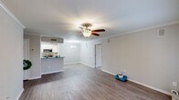 Located at 2501 Promberry Dr in Montgomery, Alabama, this single-floor home offers a well-designed layout with thoughtful finishes throughout. The spacious living area is highlighted by wood-look flooring, crown molding, and a ceiling fan with integrated lighting, creating a bright and comfortable atmosphere. Neutral-toned walls and clean white trim contribute to the open, airy feel of the main living space.

The kitchen is a standout feature, designed in a galley style with white shaker cabinetry, granite countertops, and stainless steel appliances including a refrigerator, microwave, and electric range. A peninsula with a raised countertop separates the kitchen from the living area, providing additional workspace and a casual dining option.

The bedroom offers plush carpeting, a ceiling fan, and a window that allows natural light to filter in, creating a calm retreat. The bathroom is well-appointed with wood-look flooring, a granite-topped vanity with white cabinetry, a large mirror, and a tub-shower combination. The overall design of the home is consistent and cohesive, with modern updates balanced by classic architectural details, making it a functional and comfortable single-floor residence.