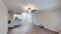 Located at 2501 Promberry Dr in Montgomery, Alabama, this single-floor home offers a well-designed layout with thoughtful finishes throughout. The spacious living area is highlighted by wood-look flooring, crown molding, and a ceiling fan with integrated lighting, creating a bright and comfortable atmosphere. Neutral-toned walls and clean white trim contribute to the open, airy feel of the main living space.

The kitchen is a standout feature, designed in a galley style with white shaker cabinetry, granite countertops, and stainless steel appliances including a refrigerator, microwave, and electric range. A peninsula with a raised countertop separates the kitchen from the living area, providing additional workspace and a casual dining option.

The bedroom offers plush carpeting, a ceiling fan, and a window that allows natural light to filter in, creating a calm retreat. The bathroom is well-appointed with wood-look flooring, a granite-topped vanity with white cabinetry, a large mirror, and a tub-shower combination. The overall design of the home is consistent and cohesive, with modern updates balanced by classic architectural details, making it a functional and comfortable single-floor residence.
