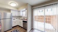 Located at 699 Wellingshire Blvd in Worthington, Ohio, this two-floor residence offers a functional and well-appointed layout across both levels. The main floor features a kitchen designed for everyday convenience, outfitted with white cabinetry, light countertops, a stainless steel double-basin sink with a pull-down faucet, a stainless steel refrigerator, dishwasher, and wood-look flooring. Natural light filters in through window blinds above the sink, while a sliding glass door with vertical blinds opens directly to a private fenced patio, creating a seamless indoor-outdoor connection. The living and entry areas are finished with neutral-toned carpet and feature a staircase leading to the upper floor. The entryway provides a welcoming transition into the main living space, which benefits from natural light through additional windows. Upstairs, the carpeted bedrooms offer a calm retreat with neutral wall tones and ample natural light. Two bathrooms serve the home — one featuring a full tub and shower with a large mirror and white vanity, and a second half-bath with a clean, minimalist design. Throughout, the space maintains a cohesive, neutral color palette that creates a bright and adaptable living environment.