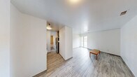 Located at 121 E Hoover Ave in Ann Arbor, Michigan, this one-bedroom, one-bathroom unit offers a practical and efficient single-floor layout. Light-toned wood-look flooring runs throughout the space, lending a clean and cohesive aesthetic that ties each room together.

The kitchen is thoughtfully appointed with rich, warm-toned cabinetry featuring brushed nickel hardware, granite countertops, a stainless steel single-basin sink, and a stainless steel refrigerator alongside a white electric range. The galley-style arrangement maximizes the available space and provides a functional flow for everyday cooking.

The bedroom is a well-proportioned retreat featuring mirrored sliding closet doors that reflect light and contribute to a more open feel. White walls and clean lines keep the room bright and versatile, while a secondary closet provides additional storage.

The bathroom is finished with classic square wall tile surrounding a full-size soaking tub with an overhead shower, complemented by a stone-patterned countertop vanity and a well-lit mirror. The neutral palette gives the bathroom a timeless and clean appearance.

Throughout the unit, white walls and consistent flooring create a bright, move-in-ready environment suited for comfortable urban living near the University of Michigan campus.