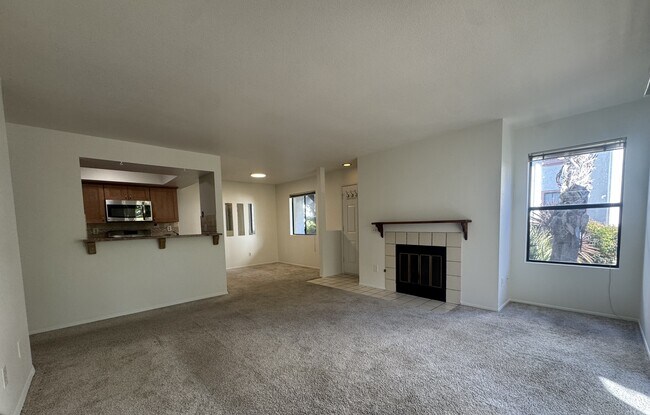 living room, dining room, fireplace, and kitchen - 9408 Twin Trails Dr