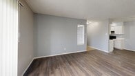 Located at 1400 Gardina St in San Antonio, Texas, this 2-bedroom, 1-bathroom single-floor unit offers a practical and cohesive layout. Throughout the space, wood-style laminate flooring and cool gray walls create a consistent, clean aesthetic, while textured popcorn ceilings add a classic residential character.

The open kitchen and living room combination serves as the heart of the unit, featuring white cabinetry in the kitchen and a sliding glass door in the living area that provides access to an outdoor space and fills the room with natural light. A hallway connects the main living area to the bedrooms and bathroom.

The primary bedroom is a comfortably sized retreat with wood-style flooring, neutral gray walls, and two side-by-side closets offering ample storage. The second bedroom also features hardwood-style flooring and a window with blinds that bring in natural light and outdoor views. Both bedrooms are connected via a shared hallway.

The full bathroom includes a tiled tub-shower combination with beige tile surround, chrome fixtures, a toilet, and a countertop with a speckled finish, offering a clean and functional space.

Overall, the unit presents a cohesive, move-in-ready interior with consistent finishes and a straightforward single-level floor plan ideal for comfortable everyday living.