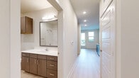 Located at 707 W Slaughter Lane in Austin, Texas, this efficient single-floor studio offers a well-designed layout that maximizes every square foot of its compact footprint. The living area features light wood-style flooring throughout, crisp white walls, and a ceiling fan that adds both comfort and a clean aesthetic. A glass-paneled door provides access to a balcony, allowing natural light to fill the space while offering pleasant outdoor views of the surrounding greenery.

The kitchen is thoughtfully appointed with a full suite of stainless steel appliances, including a range, over-the-range microwave, dishwasher, and a side-by-side refrigerator with an ice and water dispenser. Two-tone cabinetry—white uppers paired with warm wood-finish lower cabinets—frames a white countertop with an undermount sink, while a classic white subway tile backsplash adds a modern touch.

The bathroom continues the cohesive design language, featuring the same warm wood cabinetry with a white quartz countertop, an undermount sink, a large mirror, and wall-mounted storage. A full soaking tub with a tiled surround and grab bars completes the space, balancing functionality with clean, contemporary finishes. The overall ambiance is bright, modern, and move-in ready.