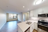 Located on Jasper Avenue NW in downtown Edmonton, Alberta, this well-appointed 1-bedroom, 1-bathroom unit offers a thoughtfully designed layout across a single floor. The open-concept living and dining area flows seamlessly into a modern kitchen, which serves as the centerpiece of the space. The kitchen features white shaker-style cabinetry, a subway tile backsplash, light quartz countertops, a peninsula with an undermount double sink, and a full suite of stainless steel appliances including a refrigerator, stove, built-in microwave, and dishwasher. Wood-look flooring runs throughout, adding warmth to the clean, contemporary aesthetic. The living area is bathed in natural light from a large picture window that frames views of the surrounding Edmonton cityscape. The bedroom is a comfortable, well-sized room with double closet doors for ample storage and its own window overlooking the city. Three closets throughout the unit provide generous storage options. The bathroom is finished with crisp white tile, a soaker tub with shower, an undermount sink set in a quartz vanity, and wood-look flooring that ties the space together. Recessed and flush-mount lighting throughout ensure a bright, inviting atmosphere in every room.