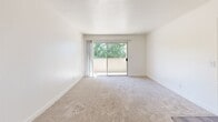 Located at 7826 Center Pkwy in Sacramento, CA, this 2-bedroom, 2-bathroom unit offers a well-organized single-floor layout designed for comfortable everyday living. The combined kitchen and living room area serves as the heart of the home, featuring wood-style flooring, a ceiling fan, and an open layout that connects the two spaces seamlessly. The kitchen is outfitted with ample gray cabinetry, light countertops, a double sink, a dishwasher, and a black refrigerator, with a window that brings in natural light. The living room opens directly to a private balcony through sliding glass doors, offering views of surrounding greenery. Both bedrooms are carpeted and bright, with windows framing outdoor foliage. The primary bedroom includes sliding glass door balcony access and generous floor space. The second bedroom is well-proportioned with natural light from a side window. Two bathrooms serve the unit, including one featuring a sliding glass shower enclosure over a full tub, wood-style flooring, and granite-style countertops. A hallway and dedicated closet provide practical storage. The unit's neutral color palette and clean finishes create a calm, functional living environment throughout.