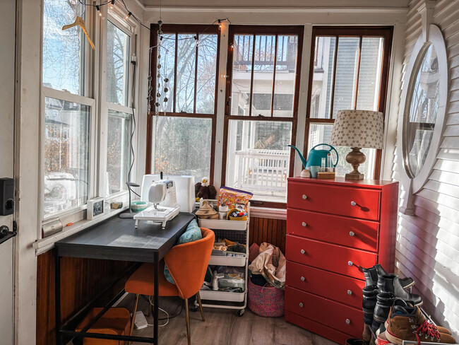 Spacious front porch with room for bookshelves, seating, a sewing nook, and more! - 819 Edmund Ave