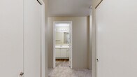 Located at 805 112th St SE in Everett, WA, this 2-bedroom, 2-bathroom residence offers a thoughtfully designed single-level layout. The open-concept living area is a standout feature, highlighted by a wood-burning fireplace with a white tile surround, plush carpeting, a ceiling fan, and a sliding glass door that opens to a private balcony with tree views. Natural light flows freely through multiple windows, creating a bright and welcoming ambiance throughout.

The kitchen is defined by white cabinetry, a breakfast bar-style pass-through counter, stainless steel refrigerator, and black appliances including a range and over-the-range microwave. It connects seamlessly to the dining and living areas, ideal for everyday functionality.

Both bedrooms are carpeted and generously sized, each offering closet space — the primary bedroom features a notably spacious footprint with its own dedicated bathroom access. With five closets total, storage is abundant throughout the unit. The hallway bathroom includes a full soaking tub and shower combination with wood-look flooring, while the second bathroom offers a walk-in shower stall, also with wood-look flooring and a vanity with white cabinetry. Baseboard heating is present throughout the home.