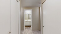 Located at 805 112th St SE in Everett, WA, this 2-bedroom, 2-bathroom residence offers a thoughtfully designed single-level layout. The open-concept living area is a standout feature, highlighted by a wood-burning fireplace with a white tile surround, plush carpeting, a ceiling fan, and a sliding glass door that opens to a private balcony with tree views. Natural light flows freely through multiple windows, creating a bright and welcoming ambiance throughout.

The kitchen is defined by white cabinetry, a breakfast bar-style pass-through counter, stainless steel refrigerator, and black appliances including a range and over-the-range microwave. It connects seamlessly to the dining and living areas, ideal for everyday functionality.

Both bedrooms are carpeted and generously sized, each offering closet space — the primary bedroom features a notably spacious footprint with its own dedicated bathroom access. With five closets total, storage is abundant throughout the unit. The hallway bathroom includes a full soaking tub and shower combination with wood-look flooring, while the second bathroom offers a walk-in shower stall, also with wood-look flooring and a vanity with white cabinetry. Baseboard heating is present throughout the home.
