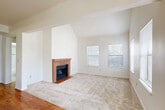 This well-appointed 2-bedroom, 2-bathroom single-story home offers a thoughtfully designed layout that maximizes both comfort and functionality. The open-concept living and kitchen area serves as the heart of the home, where hardwood flooring flows seamlessly from the kitchen into the main corridor. The living room is highlighted by soaring vaulted ceilings and a classic brick fireplace, creating a warm and inviting focal point. Multiple windows dressed with blinds allow generous natural light to fill the space throughout the day.

The kitchen features warm oak cabinetry, dark granite-style countertops, tile flooring, and stainless steel appliances including a refrigerator and electric range. A peninsula countertop provides additional prep space and separates the kitchen from the living area.

Both bedrooms are carpeted and benefit from vaulted ceilings and ample natural light from large windows. Each bedroom is served by its own closet, and the primary bedroom offers a notably generous footprint. The two bathrooms are finished with clean white tile surrounds, decorative mosaic accent borders, and full soaking tubs with shower combinations. Additional storage is provided by two dedicated closets throughout the home.