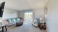 Located at 1201 E 116th Ter in Kansas City, MO, this thoughtfully laid-out single-floor residence features one bedroom, two bathrooms, a dedicated office, and a full complement of living and dining spaces. The living room serves as the heart of the home, showcasing plush carpeting, a cozy fireplace, and sliding glass doors that open to a private balcony overlooking lush tree-lined views, filling the space with natural light. The kitchen is outfitted with crisp white cabinetry, light countertops, a double sink, and hardwood-style flooring, providing a clean and functional workspace with full appliances including a dishwasher, range, and refrigerator. Adjacent to the kitchen, the dining area features a distinctive coffered ceiling detail with a ceiling fan, adding architectural character to the space. The bedroom is generously proportioned, carpeted for comfort, and includes a ceiling fan, multiple windows, and access to a dedicated closet. The office offers a bright, carpeted retreat with two windows and a ceiling fan—well-suited for remote work or a flexible use space. Both bathrooms are clean and functional, with one featuring wood-style flooring and a white vanity with under-sink storage. Throughout, neutral gray tones and consistent finishes create a cohesive, move-in ready atmosphere.
