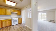 Located at 55 S Hyde Ave in Iselin, NJ, this well-appointed 2-bedroom, 2-bathroom residence offers a thoughtfully designed single-floor layout with a comfortable and functional living environment. The kitchen is equipped with warm honey-toned wood cabinetry, generous counter space, and white appliances including a gas range, dishwasher, and refrigerator. Light wood-style flooring runs throughout the kitchen, which flows seamlessly into the hallway and toward the living areas. The spacious living room features soft carpeting, a large window, and direct access to a private balcony overlooking greenery, filling the space with natural light. Both bedrooms are carpeted and bright, with the primary bedroom offering dual windows with outdoor views and ample room. The second bedroom includes a built-in closet and direct access to one of the two full bathrooms, which features tile flooring, white wall tiling, and a shower with glass doors. With four closets total, two utility rooms, and an in-unit laundry space, storage and practicality are well accounted for. The neutral color palette and clean finishes throughout give the residence a fresh, move-in-ready appeal.