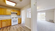Located at 55 S Hyde Ave in Iselin, NJ, this well-appointed 2-bedroom, 2-bathroom residence offers a thoughtfully designed single-floor layout with a comfortable and functional living environment. The kitchen is equipped with warm honey-toned wood cabinetry, generous counter space, and white appliances including a gas range, dishwasher, and refrigerator. Light wood-style flooring runs throughout the kitchen, which flows seamlessly into the hallway and toward the living areas. The spacious living room features soft carpeting, a large window, and direct access to a private balcony overlooking greenery, filling the space with natural light. Both bedrooms are carpeted and bright, with the primary bedroom offering dual windows with outdoor views and ample room. The second bedroom includes a built-in closet and direct access to one of the two full bathrooms, which features tile flooring, white wall tiling, and a shower with glass doors. With four closets total, two utility rooms, and an in-unit laundry space, storage and practicality are well accounted for. The neutral color palette and clean finishes throughout give the residence a fresh, move-in-ready appeal.