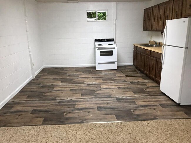 Kitchen has room for an island, table, and hutch/storage cabinet - 5650 Spainhour Mill Rd