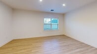 Located at 175 Rock Rd in Bergen, NJ, this well-appointed 3-bedroom, 2-bathroom unit offers a thoughtfully designed single-floor layout with modern finishes throughout. The open-concept kitchen and living area serves as the heart of the home, featuring warm honey-toned wood cabinetry, white quartz countertops, a classic subway tile backsplash, and a full suite of stainless steel appliances including a refrigerator, range, microwave, and dishwasher. A central kitchen island provides additional prep and storage space. Light hardwood flooring flows seamlessly throughout the entire unit, creating a bright and cohesive aesthetic. Recessed lighting illuminates each room, complementing the natural light that enters through multiple windows. The generously sized primary bedroom includes a dedicated walk-in closet with built-in shelving and a private en-suite bathroom finished with neutral tile flooring, a wood-toned vanity, white quartz countertop, and a glass-door walk-in shower. Two additional bedrooms feature sliding or panel-style closets and offer comfortable proportions. A second full bathroom serves the remaining bedrooms. Clean white walls, modern trim, and a consistent design language give the entire space a fresh, move-in-ready feel.