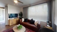 Located at 11108 Chandler Blvd in Los Angeles, CA, this single-floor unit offers a well-designed, contemporary living experience in the heart of North Hollywood. A welcoming hallway with rich hardwood flooring leads into the main living areas, setting the tone for the modern aesthetic throughout.

The living room is bright and comfortable, featuring large windows with blinds and drape treatments that invite natural light while maintaining privacy. A ceiling fan adds functional comfort to the space.

The kitchen is a standout feature, showcasing floor-to-ceiling dark cabinetry, a full suite of stainless steel appliances including a side-by-side refrigerator, range, microwave, and dishwasher, paired with clean white countertops. The space flows naturally into a dining area with a rustic wood table.

Two well-appointed bedrooms each include hardwood-style flooring, ceiling fans, and generous windows. The primary bedroom features a textured accent wall and ample natural light, while the secondary bedroom offers a similarly comfortable layout with stylish décor.

Both bathrooms are finished with large-format tile flooring, dark vanity cabinetry, white countertops, and tub-shower combinations. One bathroom features a bold patterned accent wall, while the other incorporates a rich, earthy color palette, lending each a distinct and curated character.