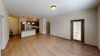 Located at 9635 Westland Cove Way in Knoxville, Tennessee, this single-floor residence offers a thoughtfully designed open-concept layout with a seamless flow between the living and kitchen areas. Light wood-style flooring runs throughout the main living spaces, creating a warm and cohesive aesthetic.

The kitchen is a standout feature, equipped with rich dark cabinetry, granite countertops, a classic subway tile backsplash, and a full suite of stainless steel appliances including a refrigerator, range, and built-in microwave. A wine rack accent and pendant lighting add character to the space, while the adjacent countertop peninsula provides additional prep and seating space.

The living area is generously proportioned with neutral-toned walls, abundant natural light through blinded windows, and direct sightlines into the kitchen — ideal for everyday living and entertaining.

The bedroom features plush carpeting, a ceiling fan with integrated lighting, and direct access to a private en-suite bathroom with a glass-enclosed shower. An additional bathroom includes a full tub-shower combination with white tile surround, open shelving, and matte black fixtures. A spacious walk-in closet with wire shelving provides ample storage. Interior doors feature classic raised-panel detailing with brushed nickel hardware throughout.