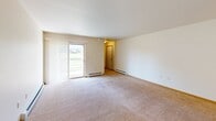 This 1120 square foot apartment in Plover, Wisconsin offers a comfortable and functional living space. The single-story layout features two bedrooms, including a primary bedroom of 210 square feet, providing ample space for rest and relaxation. The open-concept design seamlessly integrates the kitchen and living room, creating a spacious feel.

The kitchen is well-appointed with honey-colored wood cabinetry, offering abundant storage. It includes white appliances, a double sink, and a convenient breakfast bar, perfect for casual dining or food preparation. The living area is carpeted and features large sliding glass doors that flood the space with natural light and offer views of the outdoors.

Both bedrooms are carpeted and include ceiling fans for added comfort. The bathroom is equipped with a single vanity, toilet, and necessary amenities. Additional storage is available in the two closets throughout the apartment.

The neutral color palette throughout allows for easy personalization. Baseboard heating ensures comfort during colder months. This apartment combines functionality with a cozy ambiance, making it an ideal home for individuals or small families seeking a practical living space in a quiet Wisconsin community.