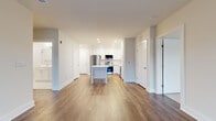 Located at 857A Federal Rd in Brookfield, CT, this well-appointed 2-bedroom, 2-bathroom residence offers a thoughtfully designed single-floor layout with a clean, modern aesthetic throughout. The open-concept living and kitchen area serves as the heart of the home, featuring warm hardwood-style flooring, recessed lighting, and a central island with a crisp white countertop. The kitchen is equipped with stainless steel appliances — including a refrigerator, range, and built-in microwave — complemented by white shaker cabinetry that extends to the ceiling for ample storage. The living room is bright and airy, highlighted by French doors that open onto a private balcony with views of the surrounding Brookfield community. Both bedrooms are carpeted for comfort, with the spacious primary bedroom offering generous dimensions and access to a well-organized walk-in closet fitted with wire shelving. The primary bathroom features a dual-sink vanity with white cabinetry, brushed nickel fixtures, a walk-in shower, and a classic black-and-white mosaic tile floor. The second bedroom benefits from a large window that fills the room with natural light. Two dedicated closets ensure practical storage throughout this move-in-ready residence.