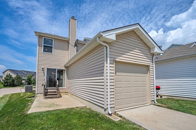 Attached one car garage in back with room in the driveway for a second car. Plenty of parking also available on the street in front. Patio has views of the pool and greenspace - 201 Countryshire Dr