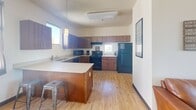 This 520 square foot apartment in Reno, Nevada offers a well-designed living space within a compact footprint. The single-floor layout comprises one bedroom, one bathroom, a kitchen, and a pantry, efficiently utilizing every inch of space.

The bedroom, measuring an impressive 270 square feet, is a standout feature. It boasts a large window that floods the room with natural light, complemented by light-colored walls and warm wood flooring. The bed is positioned to take advantage of the outdoor view, creating a serene sleeping environment.

The bathroom, while compact, is functional and modern. It features light wood flooring, a single vanity with storage, and a toilet. A small window provides natural light and ventilation.

The kitchen is a highlight, with its U-shaped design maximizing counter space. It features wooden cabinetry, black appliances, and a small island or peninsula that could serve as a breakfast bar. The open concept allows the kitchen to flow seamlessly into the living area, enhancing the sense of space.

Throughout the apartment, the use of light colors and ample windows creates an airy, open feel despite the limited square footage. The overall design prioritizes functionality without sacrificing style, making efficient use of the available space in this cozy Reno residence.
