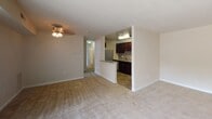 Located at 3448 Brinkley Rd in Temple Hills, Maryland, this single-floor unit offers a well-organized layout with distinct living, kitchen, bedroom, and bathroom areas. The living room is a generously sized, carpeted space anchored by a large sliding glass door fitted with vertical blinds, allowing abundant natural light and providing views of the surrounding greenery. A ceiling fan overhead adds functional comfort to the room.

The kitchen is a standout feature, finished with rich dark cabinetry, granite-style countertops, and a mosaic tile backsplash that adds visual depth. Stainless steel appliances—including a refrigerator, range, built-in microwave, and dishwasher—complement the tile flooring, creating a practical and polished cooking space. A half-wall partition separates the kitchen from the living area, maintaining an open feel throughout.

The bedrooms are carpeted and finished in neutral tones. One bedroom features a walk-in closet, while another includes a standard bi-fold closet door. Each room receives natural light through well-placed windows. The bathroom is clean and straightforward, featuring a full tub-shower combination with white tile surround. Throughout the unit, neutral wall colors and consistent flooring materials contribute to a cohesive, move-in ready atmosphere.
