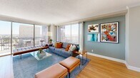 Located in the heart of downtown Houston, this well-appointed one-bedroom, one-bathroom residence offers an impressive high-rise living experience with expansive city views. The open layout connects a generous living room, dining area, and kitchen in a cohesive flow, all finished with warm hardwood-style flooring throughout.

The living room is a true highlight, anchored by floor-to-ceiling windows and sliding glass doors that open onto two private balconies, flooding the space with natural light and framing sweeping Houston skyline views. The kitchen features white cabinetry, dark granite countertops, stainless steel appliances, a tile backsplash, and a peninsula with bar seating — seamlessly connecting to a cozy dining nook.

The bedroom is a comfortable retreat with direct balcony access, large windows, and ample closet storage including double doors. Three closets are distributed throughout the unit for excellent storage. The bathroom is finished with classic white subway tile surrounding a full tub/shower combination.

A welcoming entry hallway with light-toned walls and wood flooring ties the layout together. With three closets, two balconies, and panoramic city views, this residence offers a compelling urban lifestyle in a prime Midtown Houston location.