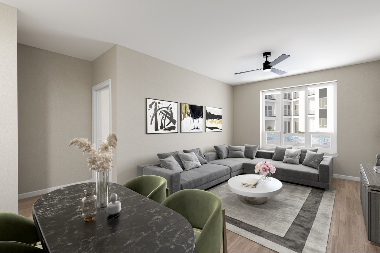Modern Living Space with Gray Sofa, Neutral Tones, and Dining Area in Foreground - Hensley at The District