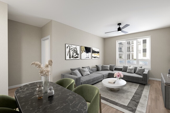 Modern Living Space with Gray Sofa, Neutral Tones, and Dining Area in Foreground - Hensley at The District
