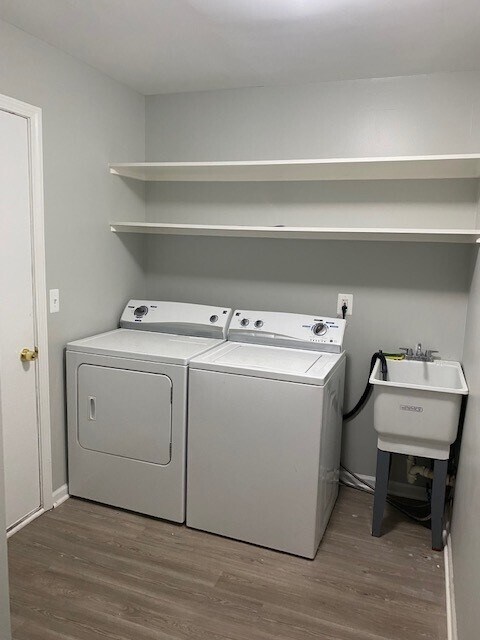 The laundry room on the basement level features full sized appliances and a rinsing sink. - 6616 Bellows Ct