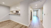 Located at 5662 La Mirada Ave in Los Angeles, CA, this well-appointed 1-bedroom, 2-bathroom residence offers a clean, modern aesthetic throughout its thoughtfully designed single-floor layout. Light wood vinyl flooring flows continuously through every room, creating a cohesive and contemporary look.

The open living room is a standout space, featuring a classic fireplace, recessed lighting, and a full-length sliding glass door that opens onto a private balcony, filling the room with natural light and offering pleasant outdoor views. The kitchen is defined by a pass-through granite countertop bar that connects to the living area, complemented by white cabinetry, stainless steel appliances including a refrigerator and microwave, and a functional layout ideal for everyday cooking.

The spacious primary bedroom includes a mirrored sliding closet, a dedicated window for natural light, and recessed lighting. Both bathrooms are finished in a consistent white palette, featuring white vanities with storage, wood-look tile flooring, and full shower-tub combinations with brushed nickel fixtures. One bathroom includes an illuminated vanity mirror with overhead lighting for added functionality.

Three hallways connect the rooms efficiently, contributing to a logical and easy-to-navigate floor plan. The overall ambiance is bright, clean, and move-in ready, reflecting a modern residential aesthetic suited for comfortable urban living in Hollywood.