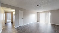 Located at 5400 S Maryland Pkwy in Las Vegas, NV, this single-floor, 5-bedroom, 2-bathroom home offers a practical and well-organized layout suited for a variety of living arrangements. The living room features durable wood-style flooring, neutral-toned walls, a textured ceiling, and a sliding glass door fitted with vertical blinds that invites natural light and provides outdoor access. The kitchen is efficiently designed with white cabinetry, a peninsula counter with a granite-style surface, white appliances including a range and full-size refrigerator, a built-in sink, and a flush panel ceiling light, all complemented by light wood-style flooring. The five bedrooms are comfortably sized, with the primary bedroom offering generous space and multiple windows. Bedrooms feature plush carpeting, neutral walls, and vertical blind-covered windows that allow ample natural light. Closet space is well-considered, with sliding-door closets providing organized storage. The two bathrooms are clean and functional, each featuring a shower-tub combination, white vanity with a granite-style countertop, and wood-style flooring. A hallway connects the rooms throughout the home, contributing to a coherent and efficient flow across the entire floor plan.