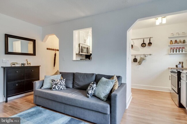 Living room with partial view of kitchen - 1363 K St SE Apartments