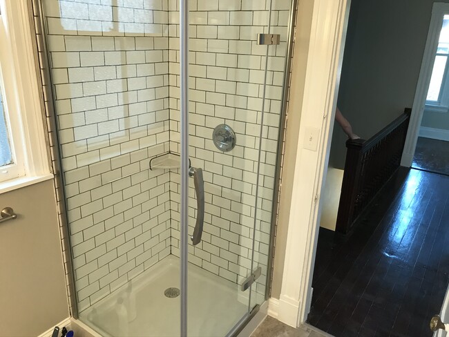 Tile shower with glass enclosure. - 2221 Oakland Ave