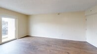 Located at 825 NW 155th Ln in Miami, FL, this single-floor, 3-bedroom, 2-bathroom unit offers a practical and well-organized layout. Wood-style plank flooring runs consistently throughout, lending warmth and visual continuity across all rooms.

The living room is a comfortably sized, open area featuring a textured ceiling, neutral walls, and a sliding glass door that brings in natural light and provides exterior access. It connects conveniently to the galley-style kitchen, which is outfitted with warm wood cabinetry on both sides, white countertops, a double sink, and white appliances including a refrigerator, dishwasher, and electric range.

The three bedrooms are each finished with the same wood-style flooring and neutral tones. Bedrooms feature sliding closet doors for built-in storage, and one room offers a window with an exterior view. A hallway connects the bedrooms to the two full bathrooms, both of which include a tub-shower combination with white tile surround, a vanity, and a mirror. The layout is efficiently designed, making practical use of the available space throughout.