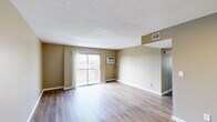 Located at 260 Oxford Dr in Winchester, Kentucky, this single-floor, 3-bedroom, 1-bathroom home offers a practical and well-organized layout. Warm neutral-toned walls and durable hardwood-style flooring flow consistently throughout, creating a cohesive and clean aesthetic across the entire home.

The living room serves as the central gathering space, featuring a sliding glass door that opens to a private balcony with outdoor views of the surrounding neighborhood, as well as a wall-mounted A/C unit and textured ceiling. It connects openly to the dining area, offering a comfortable flow for everyday living. The galley-style kitchen is outfitted with white cabinetry, a stainless steel sink with laminate countertops, and stainless steel appliances including a refrigerator and range.

The three bedrooms are each finished with the same warm flooring and neutral walls. The spacious primary bedroom includes its own closet access, while the secondary bedrooms feature large windows that bring in ample natural light and views of the outdoors. In total, the home includes five closets, providing generous storage throughout. The single bathroom is equipped with a full tub and shower combination with a clean white surround. A hallway connects the private areas of the home efficiently, completing this well-appointed and move-in ready residence.