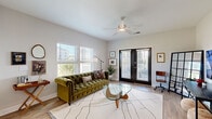 Located at 500 Liberty Ln NW in Fort Walton Beach, FL, this well-appointed single-floor residence offers a smart and efficient layout with one bedroom and two full bathrooms. The living room is a standout space, featuring light-toned hardwood flooring, large windows that invite abundant natural light, a ceiling fan, and a set of glass French doors that open to the outdoors. The kitchen is elegantly appointed with grey flat-front cabinetry, granite countertops, a subway tile backsplash, a spacious island, stainless steel appliances, and wood-look flooring — ideal for both everyday cooking and entertaining. The bedroom is a comfortable retreat, finished with plush carpet, a ceiling fan, and natural light from a large window. A decorative accent wall adds visual character to the space. The bedroom connects to a walk-in closet with wire shelving and access to a full bathroom. A second bathroom features a tub/shower combo, grey vanity with granite countertops, and matching hardwood-style flooring consistent with the rest of the home. Clean lines, neutral tones, and modern finishes throughout give this residence a cohesive and inviting ambiance suited for contemporary living.