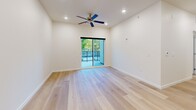 Located at 983 W State St in Hurricane, Utah, this well-appointed 3-bedroom, 2-bathroom unit offers a thoughtfully designed single-floor layout. The open-concept living area seamlessly connects the living room, dining area, and kitchen, all finished with light-toned hardwood flooring that enhances the bright, airy atmosphere. Recessed lighting and a ceiling fan keep the space comfortable, while a sliding glass door leads directly to a private balcony with outdoor views.

The kitchen is a standout feature, equipped with rich dark wood cabinetry, white quartz countertops, stainless steel appliances including an electric range, pendant lighting over the sink, and access to a dedicated pantry for additional storage.

The primary bedroom is generously sized, with direct balcony access, a ceiling fan, and a walk-in closet outfitted with dual hanging rods and shelving. The additional bedrooms feature plush carpeting, ceiling fans, and natural light from exterior windows. Each bedroom benefits from its own closet space.

Both bathrooms are finished in a clean, modern style with dark wood vanities, white countertops, and tub-shower combinations. A dedicated laundry room and a central hallway connecting all rooms round out this functional and well-designed home.