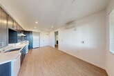 This well-appointed one-bedroom, one-bathroom unit is located in Sonoma, CA, and offers a thoughtfully designed single-level layout. The open-concept living, dining, and kitchen area forms the heart of the space, bathed in natural light from large windows with blinds and a glass door leading to a private balcony with outdoor views. The kitchen is a standout feature, boasting floor-to-ceiling dark espresso cabinetry, white quartz countertops, a stainless undermount sink, and white appliances including a range, dishwasher, and refrigerator. Recessed lighting and a wall-mounted mini-split HVAC unit add both function and a clean, modern aesthetic throughout the main living area. Light wood-style flooring runs consistently throughout the unit, creating a cohesive and warm feel. The bedroom is a comfortable, bright retreat with a large window overlooking greenery, a wall-mounted mini-split unit, and a spacious sliding-door closet. The hallway provides additional closet storage. The bathroom is clean and modern, featuring a full soaking tub with subway tile surround, a dark vanity with quartz countertop, an undermount sink, and a large mirror. This unit combines practical functionality with contemporary finishes in the heart of California's wine country.