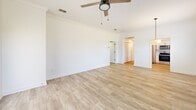 This contemporary single-story residence offers 1,080 square feet of well-designed living space. The home features two bedrooms, including a spacious primary bedroom of 210 square feet, and two full bathrooms. The interior is characterized by its bright and airy ambiance, enhanced by multiple windows that allow natural light to flood the rooms.

Throughout the home, wood-look flooring adds warmth and elegance to the space. The living area is open and inviting, with a ceiling fan for comfort and ample room for furniture arrangements. The updated kitchen boasts white cabinetry, stainless steel appliances, and a window overlooking the exterior, creating a pleasant cooking environment.

A dedicated laundry room with full-sized washer and dryer units adds convenience to daily life. The bathrooms are clean and modern, featuring white fixtures and neutral tones. Generous closet space, including a walk-in closet, provides ample storage solutions.

The attached garage offers secure parking and additional storage options. The property's location in Tampa, FL at 2027 Villa Sites Dr ensures easy access to urban amenities while maintaining a residential feel. This home's efficient layout and modern updates make it an attractive option for those seeking a contemporary living space in a desirable Florida location.