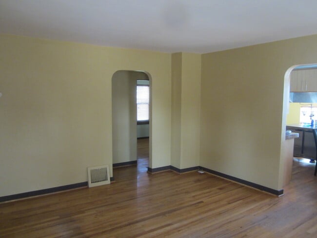 Left doorway off living room leads to two bedrooms and bathroom. Doorway on right leads to kitchen. - 7605 Robinson Way