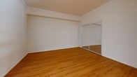 Located at 550 N Figueroa in the heart of Downtown Los Angeles, this efficiently designed studio offers a well-organized single-floor layout that maximizes every square foot. The open-plan living area features warm hardwood flooring throughout, crown molding, and track lighting, creating a bright and cohesive atmosphere.

The kitchen is a standout feature, appointed with light natural wood cabinetry, rich dark granite countertops, and a full suite of stainless steel appliances including a refrigerator, range, built-in microwave, and dishwasher. A peninsula counter provides additional prep space and serves as a natural divider between the kitchen and living area.

The sleeping area is defined by mirrored sliding closet doors that reflect light and contribute to a sense of openness within the compact footprint. Crown molding continues throughout, adding a refined architectural touch.

The bathroom is finished with matching light wood cabinetry, a granite-topped vanity, a large framed mirror with overhead lighting, and a full tub-shower combination enclosed by glass sliding doors. Neutral tile flooring completes the clean, functional aesthetic.

Overall, this studio presents a consistent and practical design with quality finishes throughout, ideally situated for urban living in one of Los Angeles's most central neighborhoods.