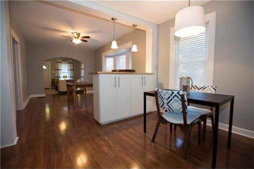 dining area/living area in background with large bay windows and plenty of light - 3418 Genessee St