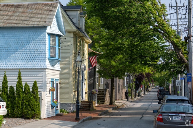 Sunshine glancing through the leaves along this Newport neighborhood street gives a comfortable shady walkway.