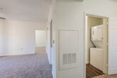 This single-floor residence offers a thoughtfully designed layout that balances comfort and functionality throughout its connected living spaces. The open-concept living area is bright and inviting, finished with soft wall-to-wall carpeting and topped by a ceiling fan that enhances airflow and ambiance. Sliding glass doors lead to an outdoor patio, allowing natural light to pour in and providing easy access to the exterior.

The kitchen is efficiently designed and well-equipped, featuring white cabinetry, granite-style countertops, stainless steel appliances including an electric range with overhead microwave, a double-basin sink, and wood-look hard flooring. A window fitted with blinds keeps the kitchen bright while offering privacy.

The bedrooms are carpeted and generously sized, each maintaining the home's clean, neutral aesthetic. One bedroom includes a walk-in closet with built-in shelving and hanging rods, offering ample storage space.

The bathroom is finished with wood-look hardwood flooring and includes a tub-shower combination, a white vanity with granite-style countertop, and a mirror. Its elongated layout provides a functional and uncluttered feel. Throughout the residence, crisp white walls, white trim, and consistent finishes create a cohesive and move-in-ready environment.