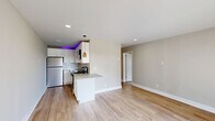 Located at 119 Sanders Ferry Road in Hendersonville, Tennessee, this 2-bedroom, 1-bathroom unit offers a thoughtfully updated interior with a clean, modern aesthetic. Light hardwood flooring flows consistently throughout the living spaces, complementing the warm neutral wall tones that create a cohesive and inviting atmosphere.

The kitchen is a standout feature, showcasing white shaker cabinetry, granite countertops, a herringbone tile backsplash, and a full suite of stainless steel appliances including a refrigerator, electric range, and over-the-range microwave. The combined kitchen and living room area provides an efficient, open layout well-suited for everyday living.

The spacious primary bedroom offers generous proportions, with large windows that invite abundant natural light and views of the surrounding greenery. The second bedroom also features a window with outdoor views and baseboard heating. Both bedrooms are finished with the same light hardwood flooring and neutral palette found throughout the unit.

The bathroom features marble-look tile flooring, a white vanity with a solid surface countertop, brushed nickel fixtures, and a tiled shower, presenting a clean and contemporary finish. Recessed lighting in the living area adds a polished touch to this well-appointed home.