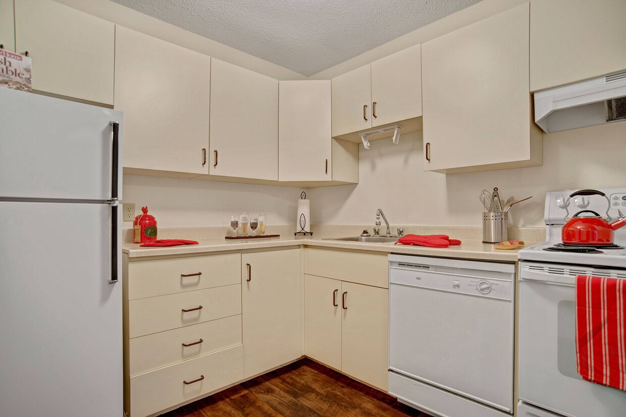 A kitchen with white appliances and white cabinetry - Spruce Meadow