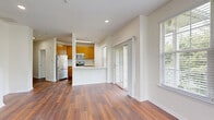Located at 40 East Hanover Avenue in Morris Plains, NJ, this 2-bedroom, 2-bathroom residence at The Wisteria delivers a comfortable and functional layout with thoughtful design throughout. Rich hardwood-style flooring flows consistently across every room, lending warmth and visual continuity to the entire space.

The combined dining and living area is generously proportioned, bathed in natural light from multiple large windows and a sliding glass door that opens to a private balcony with outdoor views. The kitchen features warm wood cabinetry with brushed gold hardware, white countertops, stainless steel appliances, a herringbone tile backsplash, and a pass-through counter that connects seamlessly to the living area.

A wide, well-lit hallway connects the main living spaces to the bedrooms and bathrooms, lined with multiple closets for abundant storage. The primary bedroom is spaciously sized with room for a full furniture arrangement, while the second bedroom benefits from a large window that brings in natural greenery views. Four closets total — including a walk-in — provide excellent storage capacity. Both bathrooms are cleanly finished, with one featuring a full soaking tub and white cabinetry. A dedicated laundry room and utility room add practical convenience to this well-rounded residence.