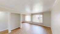 Located at 5965 Evergreen Road in Dearborn Heights, MI, this well-appointed one-bedroom, one-bathroom unit offers a clean, modern aesthetic throughout its efficiently designed single-floor layout. Light-toned hardwood flooring flows seamlessly across every room, creating a cohesive and airy feel.

The combined kitchen and living area serves as the heart of the home. The living room is generously proportioned, featuring large windows dressed with vertical blinds that invite abundant natural light and offer views of the surrounding greenery. A ceiling fan adds both comfort and character to the space. The kitchen is thoughtfully updated with crisp white shaker cabinetry, dark granite countertops, a stainless steel refrigerator, gas range, and built-in microwave, all complemented by a single-basin sink.

The spacious primary bedroom comfortably accommodates full furnishings and includes a ceiling fan, a wall-mounted HVAC unit, ample closet space with double doors, and a bright window with vertical blinds that fills the room with natural light.

The bathroom is tastefully finished with large-format marble-style tile on both the floors and tub surround, paired with a white vanity topped with granite and brushed nickel fixtures. A connecting hallway ties all rooms together, completing this practical and attractive unit.
