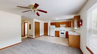 Located at 229 S Kendall Ave in Kalamazoo, Michigan, this multi-floor home spans three levels and offers four bedrooms and three bathrooms, providing ample space for comfortable living. The layout is distributed thoughtfully across each floor, with the lowest level offering a compact yet functional footprint, the middle floor providing slightly more space, and the uppermost level being the largest of the three.

The kitchen is outfitted with warm oak cabinetry, white appliances including a gas range, refrigerator, and dishwasher, and light tile flooring. Multiple windows allow natural light to fill the kitchen and adjacent area, with views of the surrounding greenery outside. Counter space is generous, and the overall layout is efficient and practical.

Each bedroom features neutral carpet flooring, white walls with warm wood-trimmed doors and baseboards, and built-in closets with bifold or panel doors. The bedrooms are well-proportioned, with the primary bedroom offering a comfortable amount of space. Natural light reaches several bedrooms through windows overlooking the outdoors.

The three bathrooms include a combination of tub/shower units and a standalone shower stall, all finished with light tile flooring. One bathroom features a wood-cabinet vanity with a wall-mounted mirror and overhead lighting. The consistent use of warm wood tones and neutral finishes throughout the home creates a cohesive and practical aesthetic.